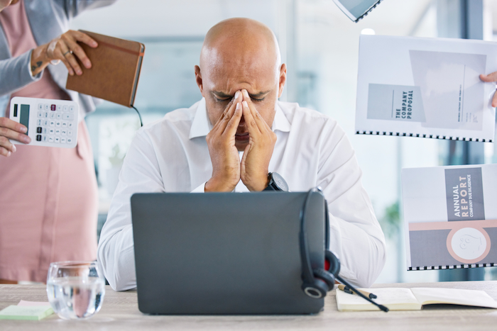 Man at the office is really stressed because of workload and deadlines